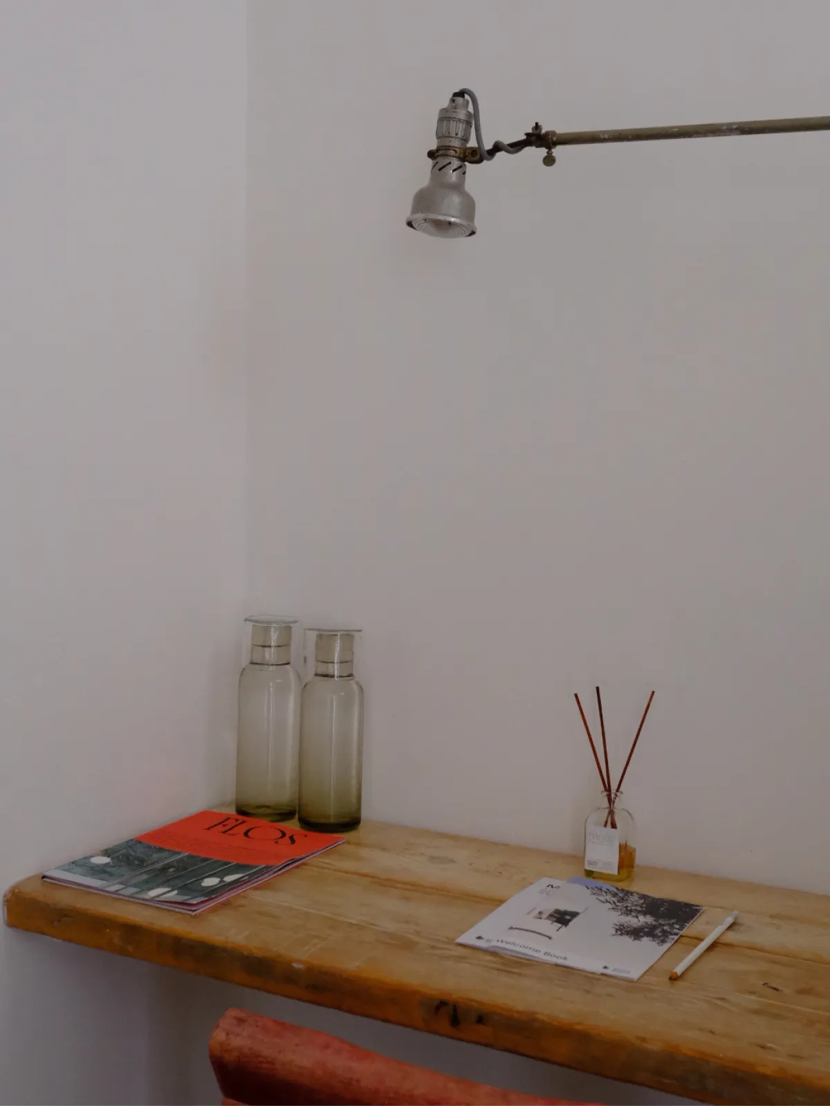 A pump bottle and natural loofah styled on a warm-toned surface.
